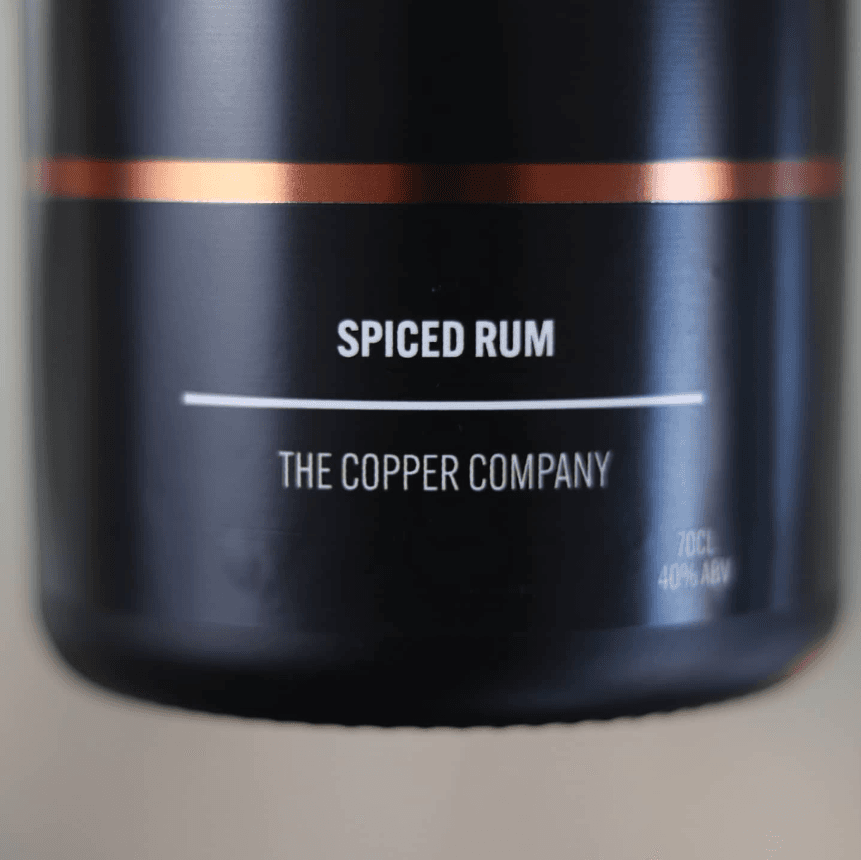 Copper Company rum bottle back, secondary label with tasting notes and repeating monogram pattern