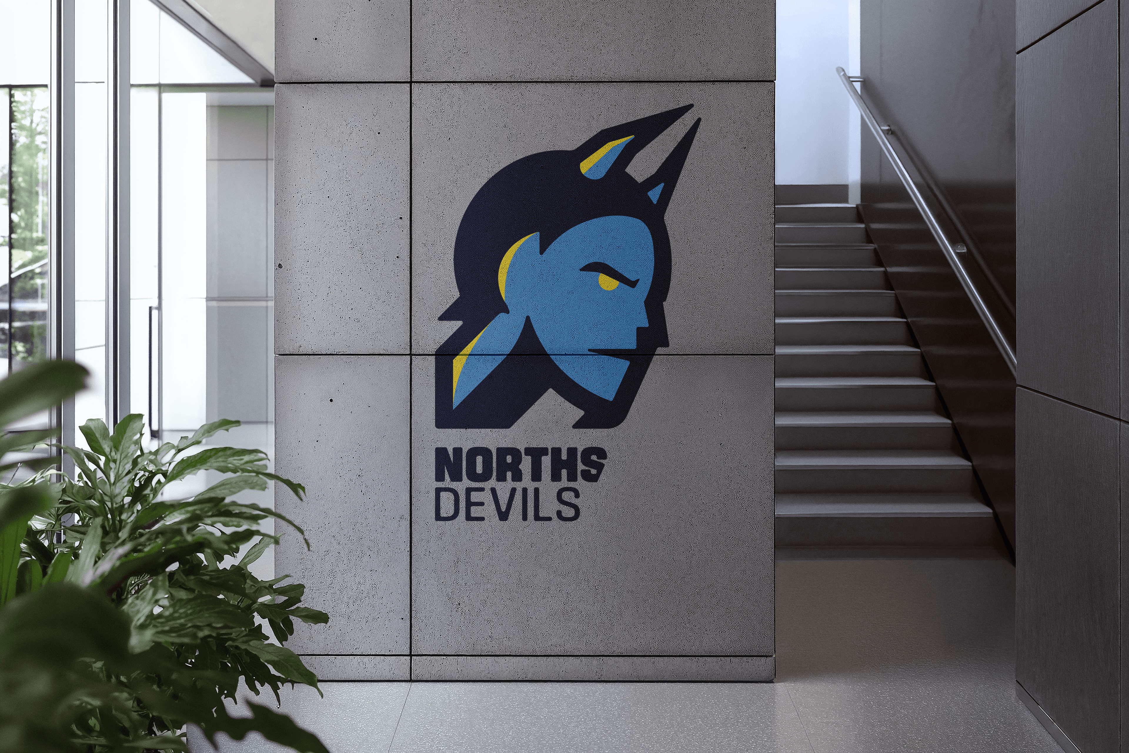 Norths Devils refreshed logo on concrete wall mockup, environmental scale brand application
